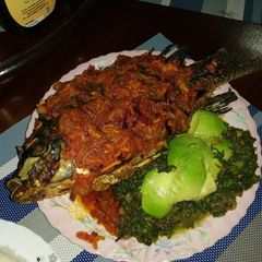 A picture of Juicy wet fry fish with ugali.