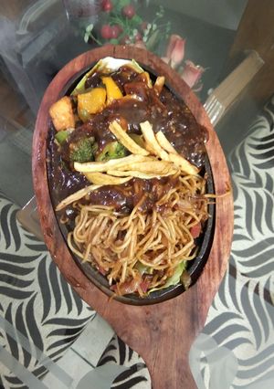 A picture of Veg sizzler of sehezwan hakka noodles with sauteed vegetable.