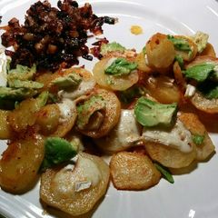 A picture of Fried spiced potatoes with brie, avocado and caramelized onions.