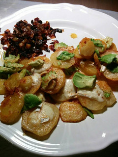A picture of Fried spiced potatoes with brie, avocado and caramelized onions.