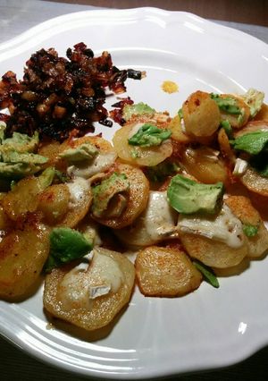 A picture of Fried spiced potatoes with brie, avocado and caramelized onions.