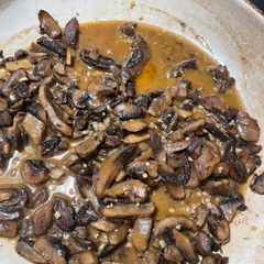 A picture of Sautéed mushrooms in wine and garlic.