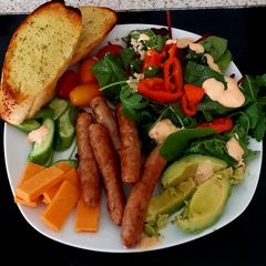 A picture of My Pork Sausage Salad with chedder Cheese & Garlic Bread.