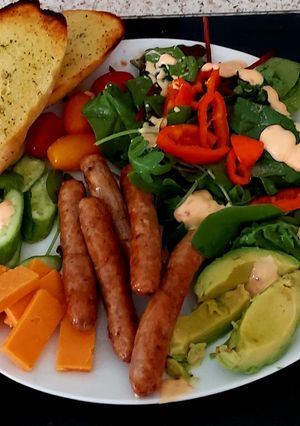 A picture of My Pork Sausage Salad with chedder Cheese & Garlic Bread.