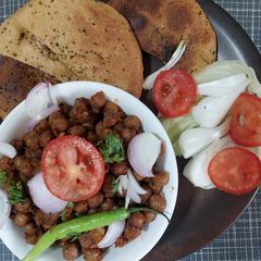 A picture of Pindi Chole with wheat Kulcha.