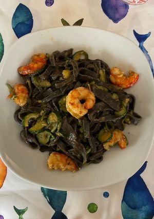 A picture of Homemade Squid Ink Tagliolini with Jumbo Shrimp and Zucchini.