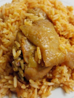 A picture of Jollof rice with fried chicken.