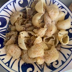 A picture of Shell pasta with lamb, Parmesan, almonds and oils.