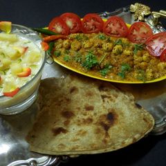A picture of Pineapple basundi,mava makhana,parantha with salad.