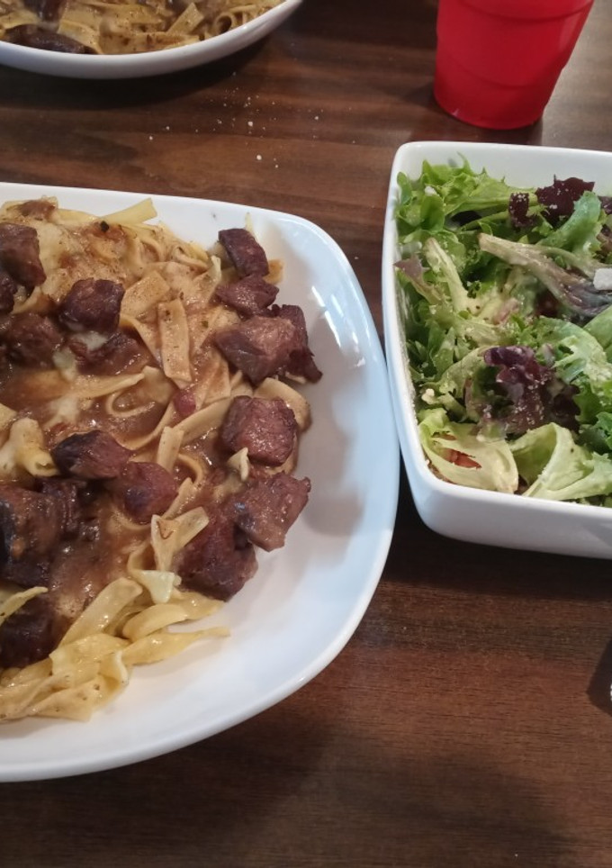 A picture of Beef and Noodles with Spring Salad.