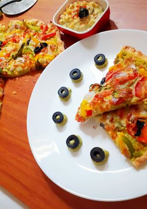A picture of Spinach Hummus Thin Crust Pizza with Hummus Salad.