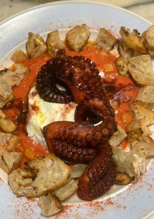 A picture of Grilled Octopus on Salmorejo Crostini with Mozzarella Cream.