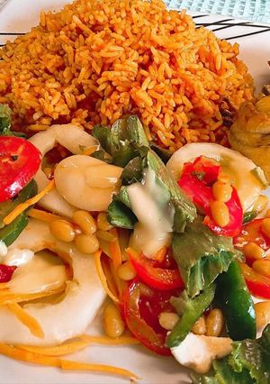 A picture of Jollof rice,fried chicken and salad.
