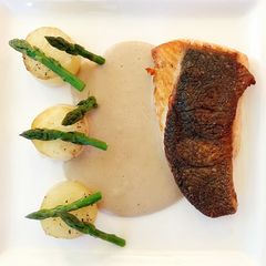 A picture of Crispy Skin Salmon, Asparagus with Fondant Potato and Chestnut Sauce.