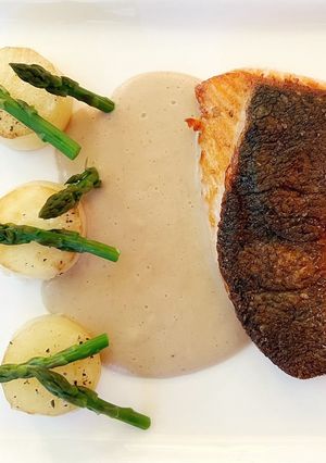 A picture of Crispy Skin Salmon, Asparagus with Fondant Potato and Chestnut Sauce.