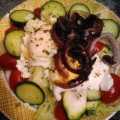 A picture of Poached eggs on salad.