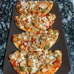 A picture of Chicken nuggets pizza.