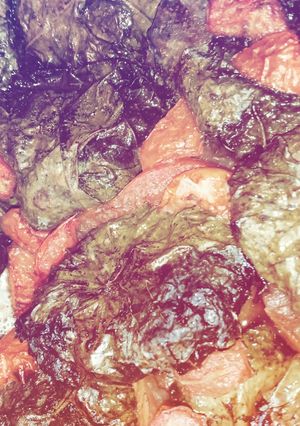 A picture of Meat wrapped in vine leaves.