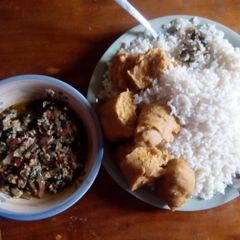 A picture of Rice and moimoi with vegetable egg sauce.