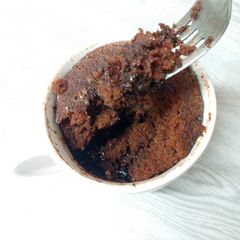 A picture of Microwaved lava cake in mug.