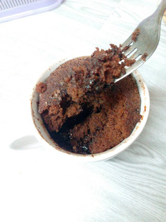 A picture of Microwaved lava cake in mug.