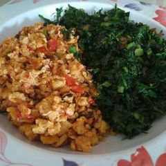 A picture of Fried eggs with sauted kales.