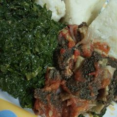 A picture of Stripes(matumbo) with greens and ugali.
