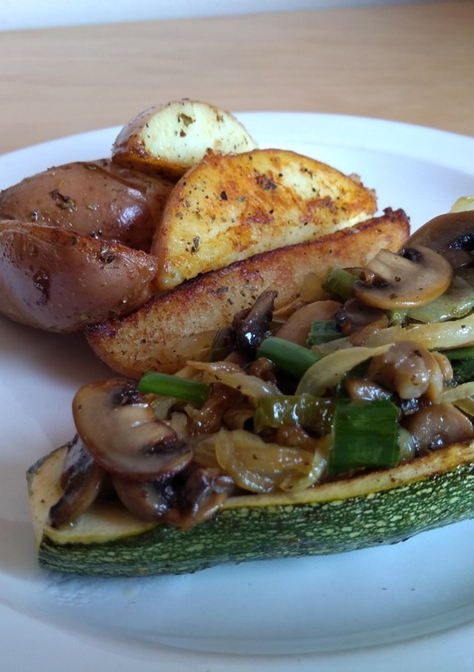 Una foto de Papas rústicas y zapallo italiano relleno de verduras salteadas