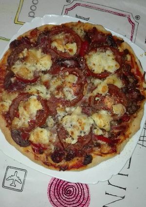 Una foto de Pizza de carne de venado champiñones, jamón y queso de rulo de cabra 