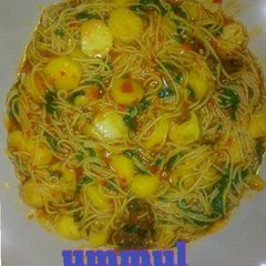 A picture of Spaghetti jollof with Irish potatoes.