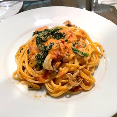 A picture of Seafood tomato cream pasta with kale.