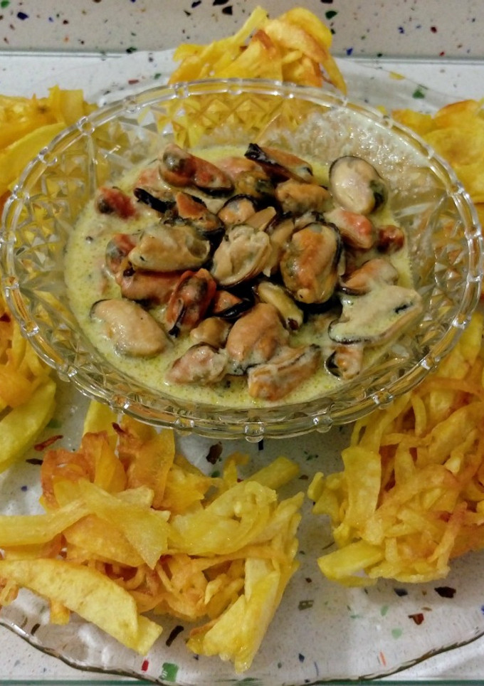 Una foto de Nidos de patatas fritas y mejillones en salsa