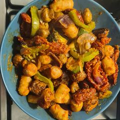 A picture of Chicken sausage vegetable tray bake with red pesto.