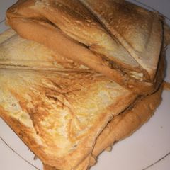 A picture of Toast bread with sardines and boiled eggs.
