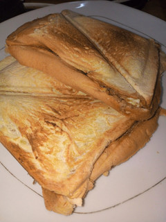 A picture of Toast bread with sardines and boiled eggs.