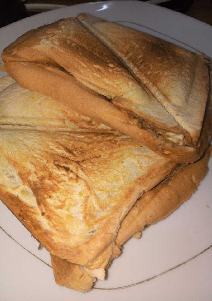 A picture of Toast bread with sardines and boiled eggs.