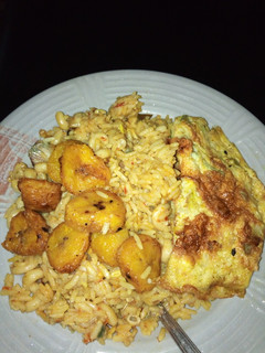 A picture of Jollof rice, plantain and egg.