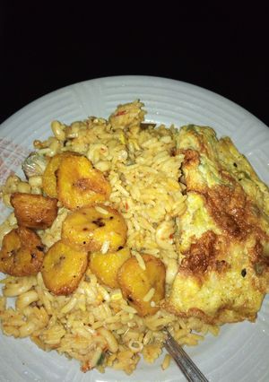 A picture of Jollof rice, plantain and egg.