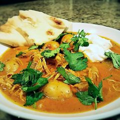 A picture of Indian spiced stew with chicken and potatoes.