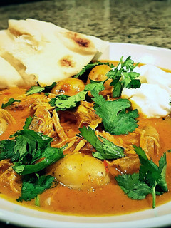 A picture of Indian spiced stew with chicken and potatoes.