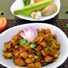 A picture of Raw Banana Curry with Green Peas.