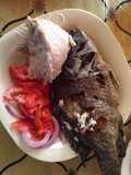 Ugali wa mtama served with fried fish and kachumbari