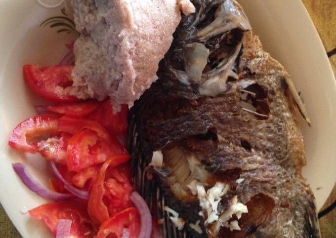 Ugali wa mtama served with fried fish and kachumbari