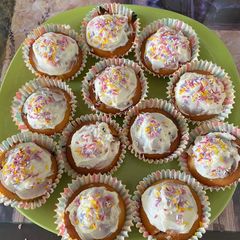Strawberry cupcakes with vanilla frosting and sprinkles A picture of Strawberry cupcakes with vanilla frosting and sprinkles.