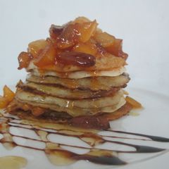 A picture of Wheat flour pancake with caramelized fruits and honey glaze.