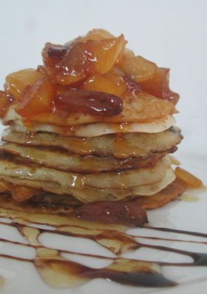A picture of Wheat flour pancake with caramelized fruits and honey glaze.