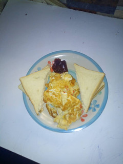 A picture of Bread and omellete with jam.