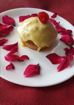 A picture of Eggless mawa cup cake topping with shrikhand.
