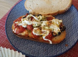 Una foto de Burrata con pesto, aceitunas y tomate