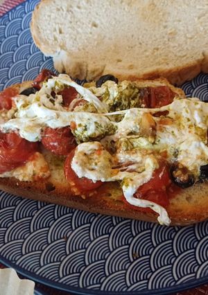 Una foto de Burrata con pesto, aceitunas y tomate